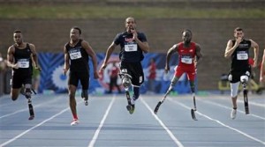 Runners (l-r) Michael Asefa, Desmond Jackson, Shaquille Vance, Regas Woods, and Trevor Wallace compete in the men's 100-meter dash final race during the U.S. Paralympics Team Trials in Charlotte, N.C. (AP Photo/Chuck Burton)